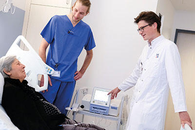 PD Dr. Kevin Schulte und Oberarzt Dr. Thorben Schrumpf erläutern der Patientin die Funktion der automatisierten Peritonealdialyse